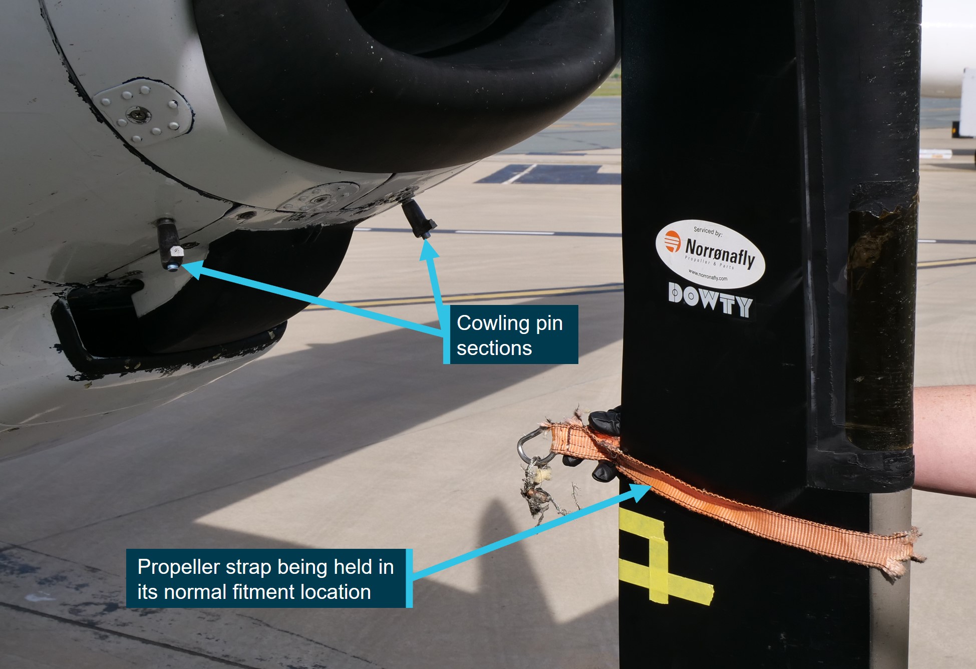 Figure&nbsp;2: Cowling pin sections that remained secured in the engine cowling, and the damaged propeller strap shown in the normal fitment location after being recovered from the fuselage