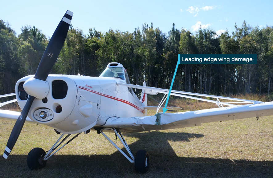 A photo of the Pawnee after the accident. An indentation can be seen on the leading edge of the left wing, inboard of the strut. 