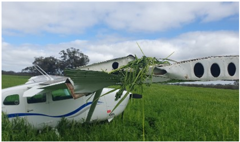 Occurrence Cessna 206 showing damage to right wing tip and the flap remaining extended in the 10 degree position, blocking the forward cargo door 