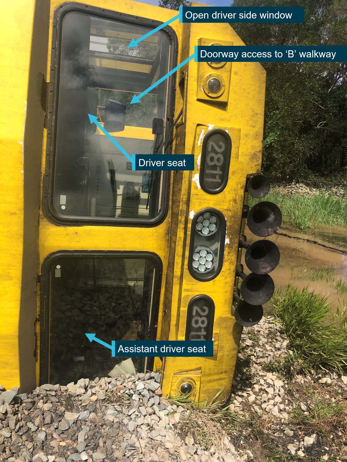 Front view of drivers cab at the number 2 end of the derailed and overturned locomotive 2811.