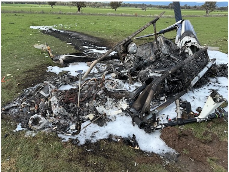 This image shows the post-impact damage to the helicopter, destroyed by fire.