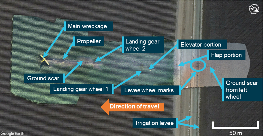 Overhead view of aircraft wreckage distribution in field.