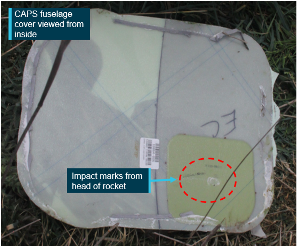 Picture of the aircraft parachute outer fuselage cover with an impact mark from the rocket.