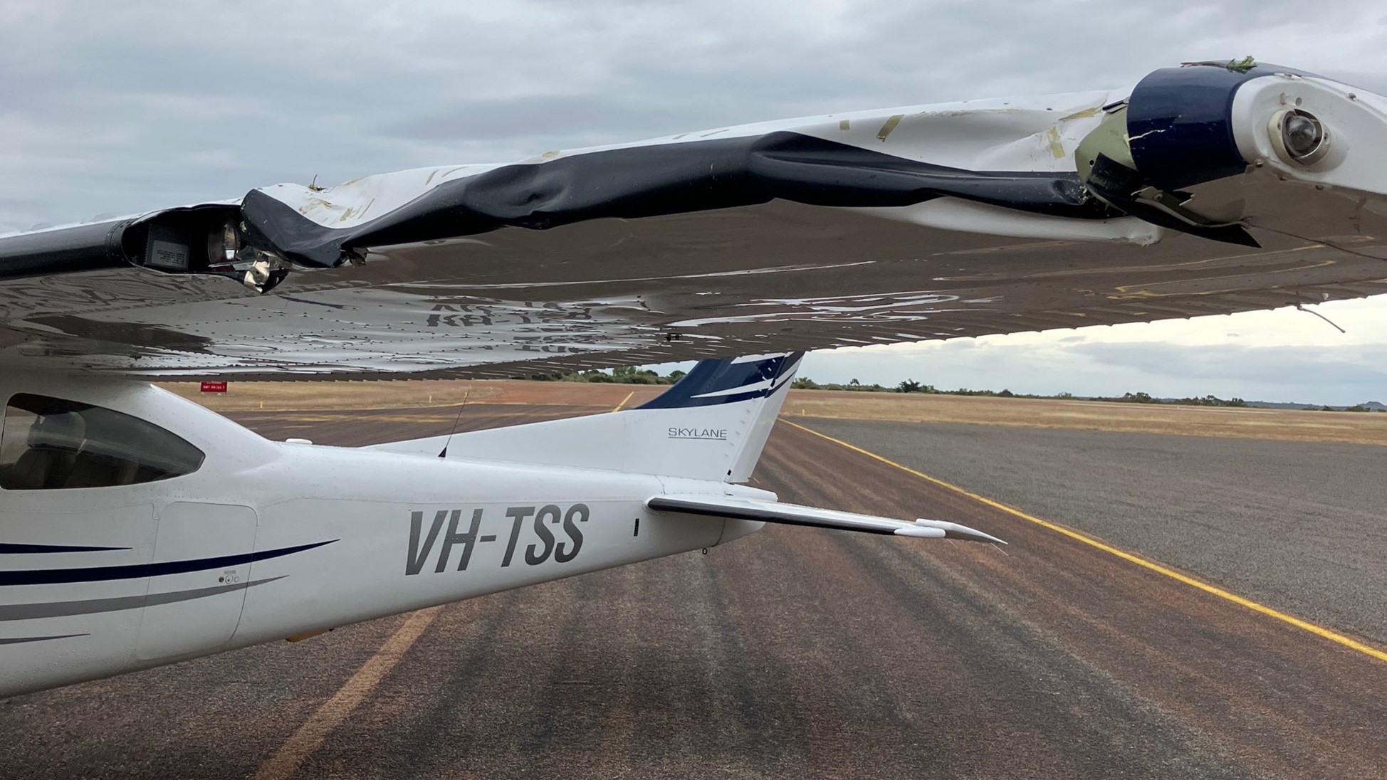 VH-TSS left wing showing significant damage due to impact with the tree