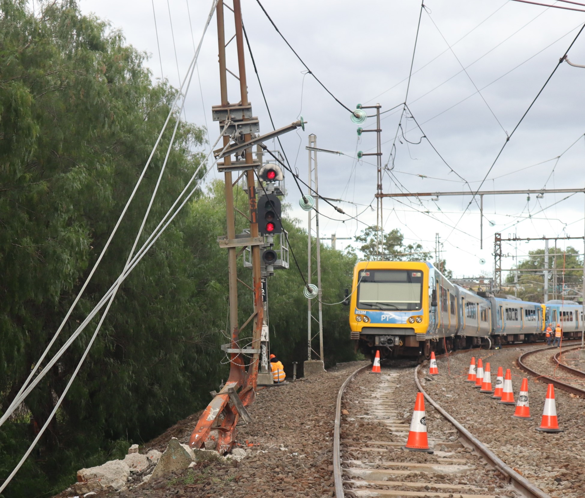 The damaged stanchion, with the derailed train in its final position in the distance