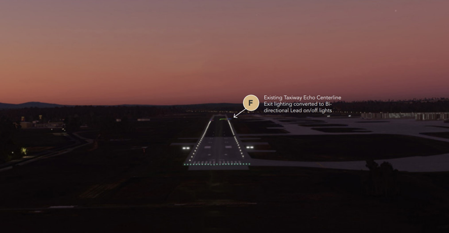 Image from an elevated position, of a runway extending into the distance. The runway has a row of green lights at the threshold, white runway edge lights extending up to 6 barely visible red runway end lights. Green taxiway lights extend off to the right from the runway end.