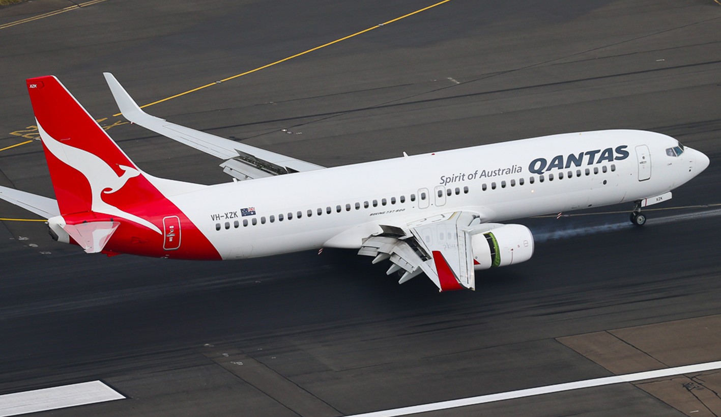 Qantas Boeing 737-800 (VH-XZK) on the ground at an airport.