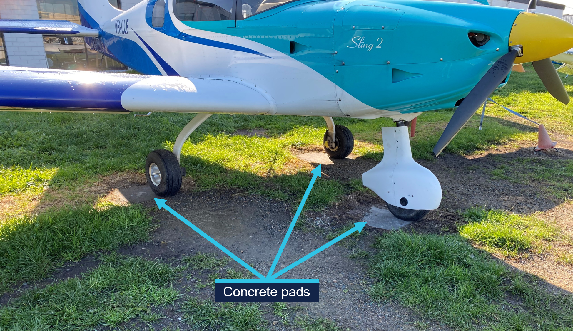 A picture of a Sling LSA parked on concrete pads, which are surrounded by gravel and grass.