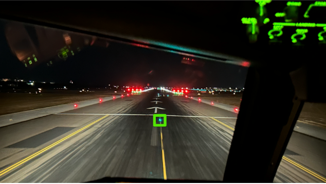 Photo taken from an Emirates Boeing 777 cockpit highlighting the last green taxiway light as the cue for the runway 23 SOT position