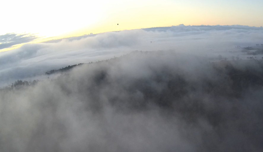 Image from onboard video recorder showing thick fog below flight path