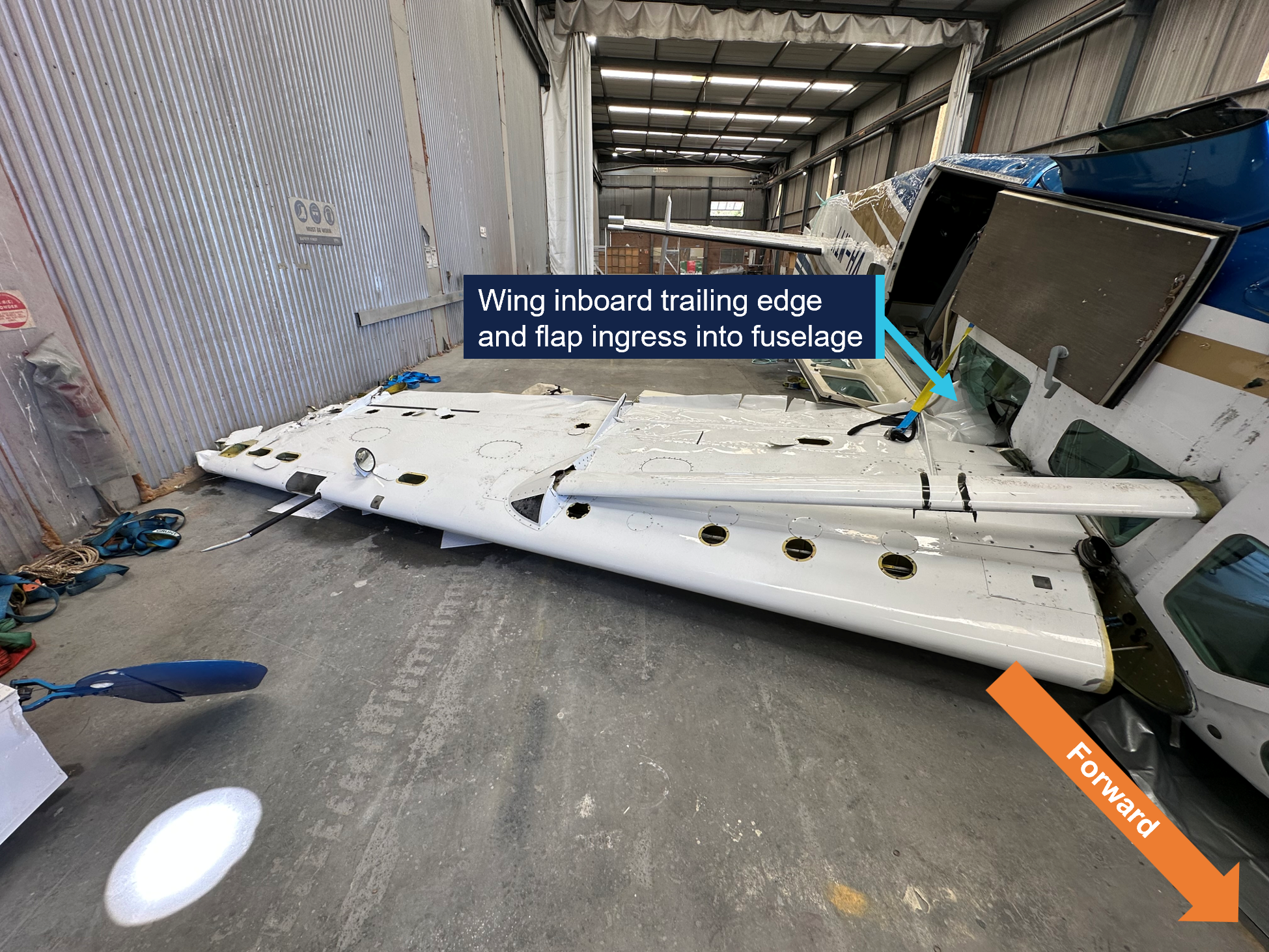 Ingress of left wing into VH-WTY fuselage. Image depicts inverted aircraft facing aft