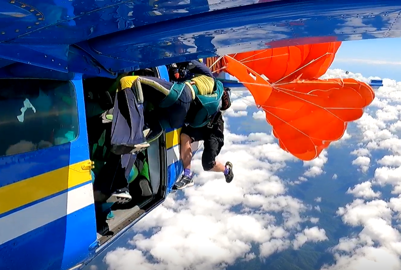 Reserve parachute inflating and dragging the parachutist rearwards
