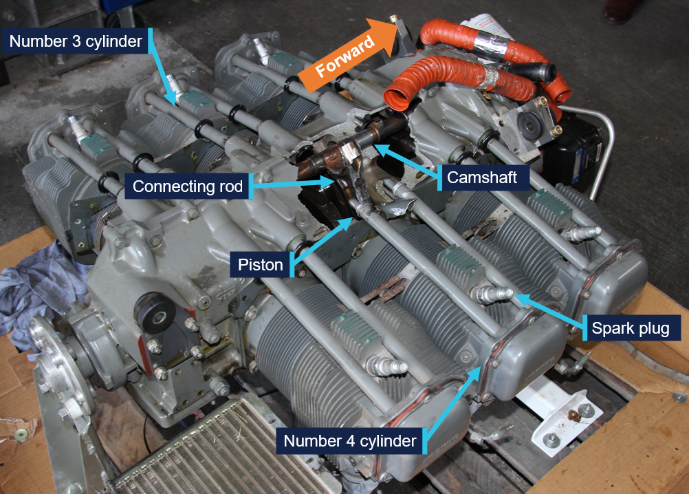 View of the engine showing the large hole in the crankcase behind the number 4 cylinder, with the number 4 connecting rod protruding from the hole.