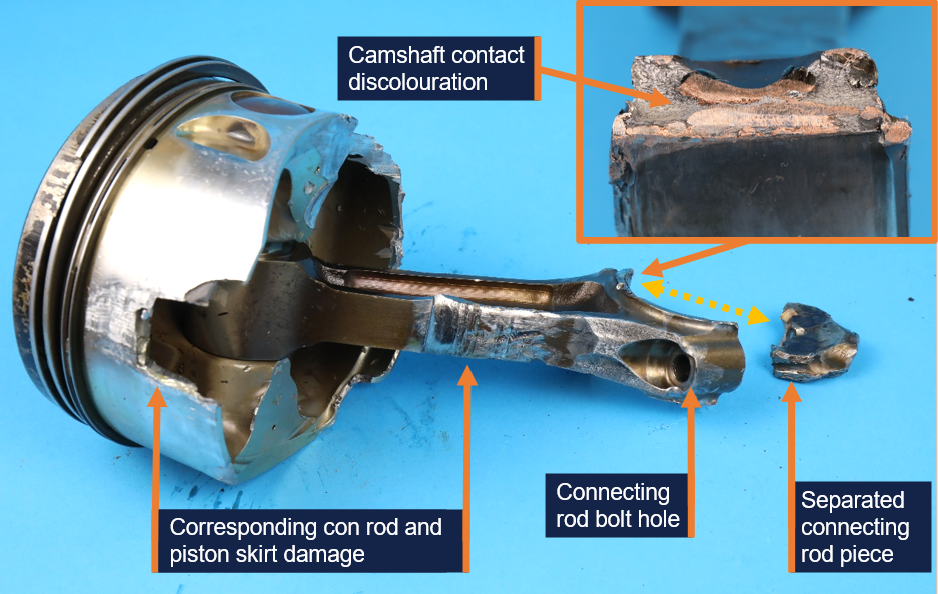 Number 4 cylinder connecting rod and piston also showing the separated section of connecting rod and copper discolouration from camshaft contact.
