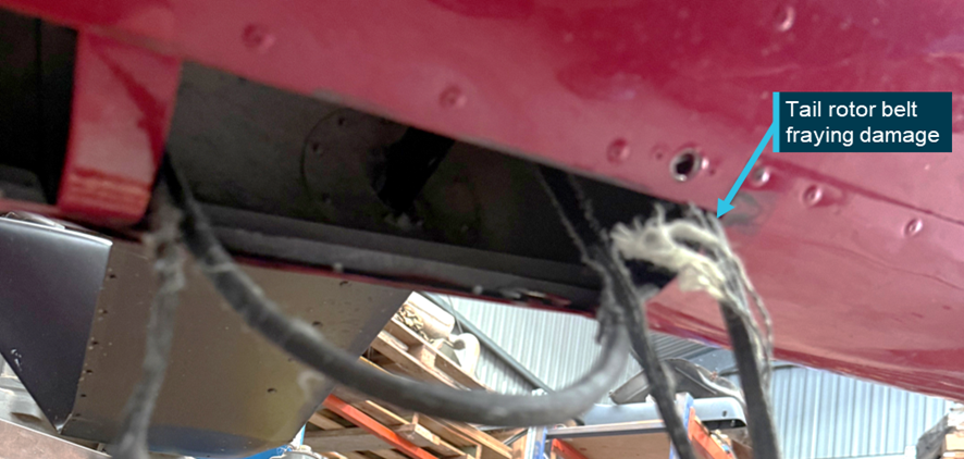 Remnants of a loose / fractured tail rotor drive belt found within the tail boom
