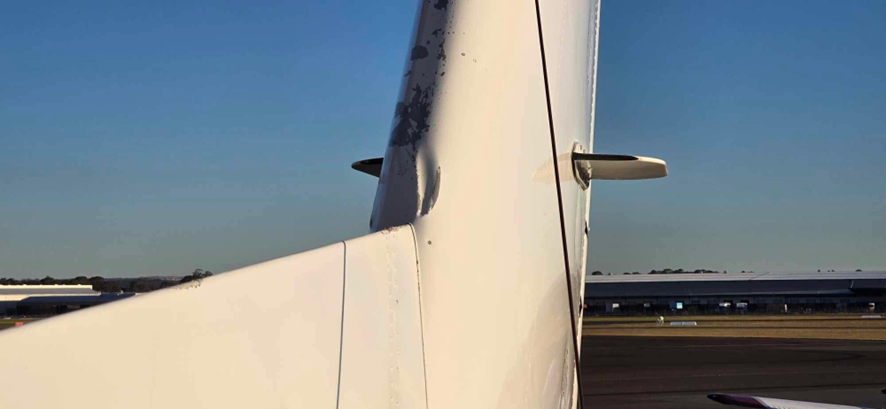 A photograph of the vertical stabiliser showing damage.