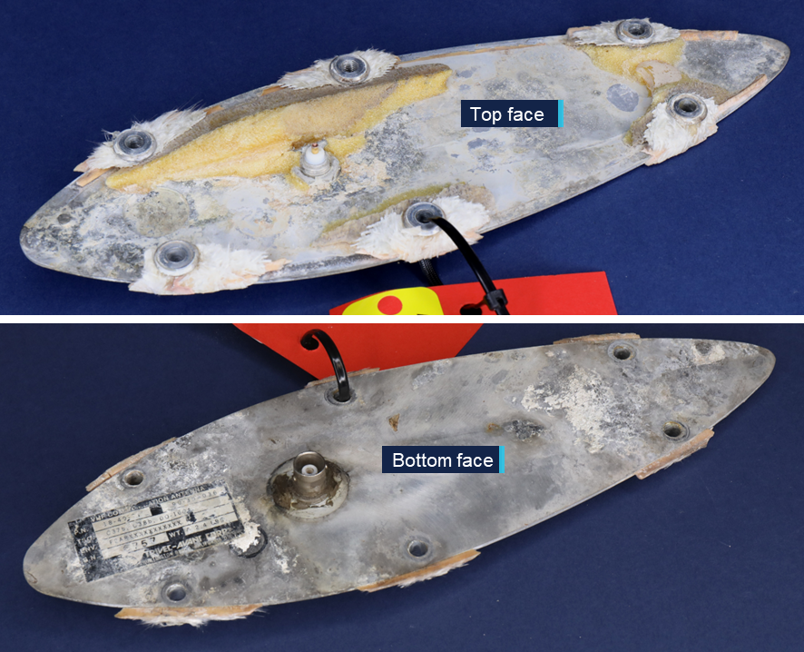 Close-up photographs of the top and bottom faces of the antenna base removed from VH-EEL.