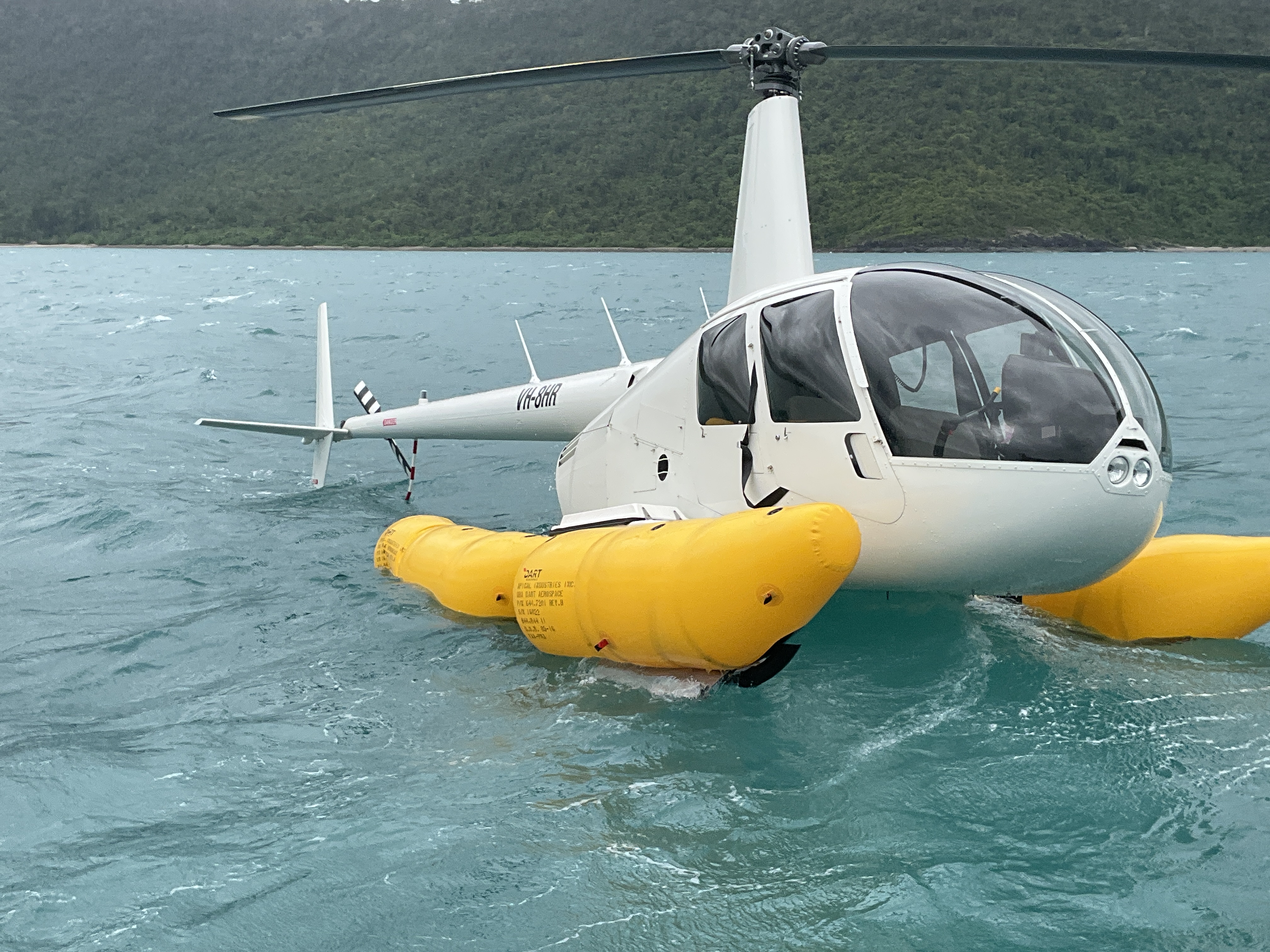VH-8HR floating on the ocean with emergency pop-out floats inflated.