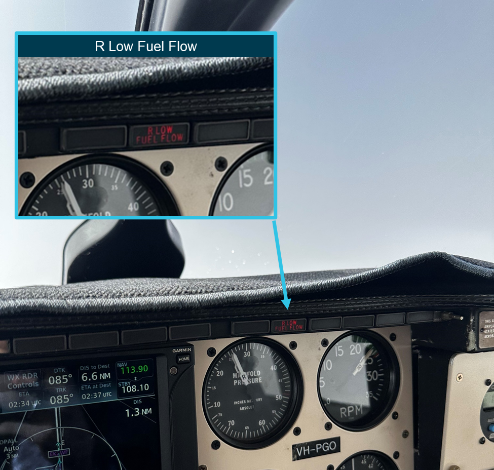 Photograph taken of the dashboard in flight by the pilot showing the R LOW FUEL FLOW illuminated