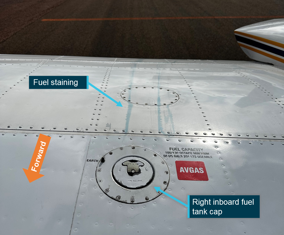 Photographs of the top of the right wing showing blue fuel stains emanating from the fuel cap
