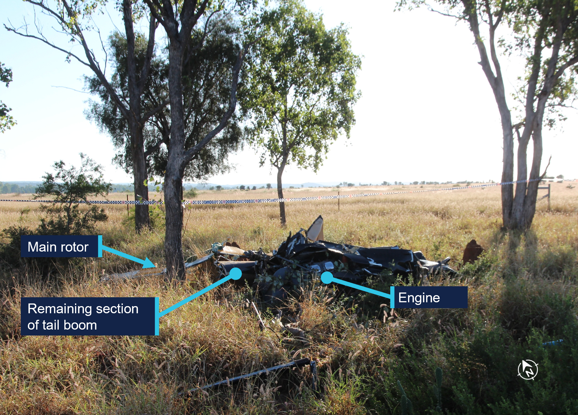 Figure 2 showing the main wreckage of VH-ESG, its engine, the remaining section of the tail boom, and the main rotor.