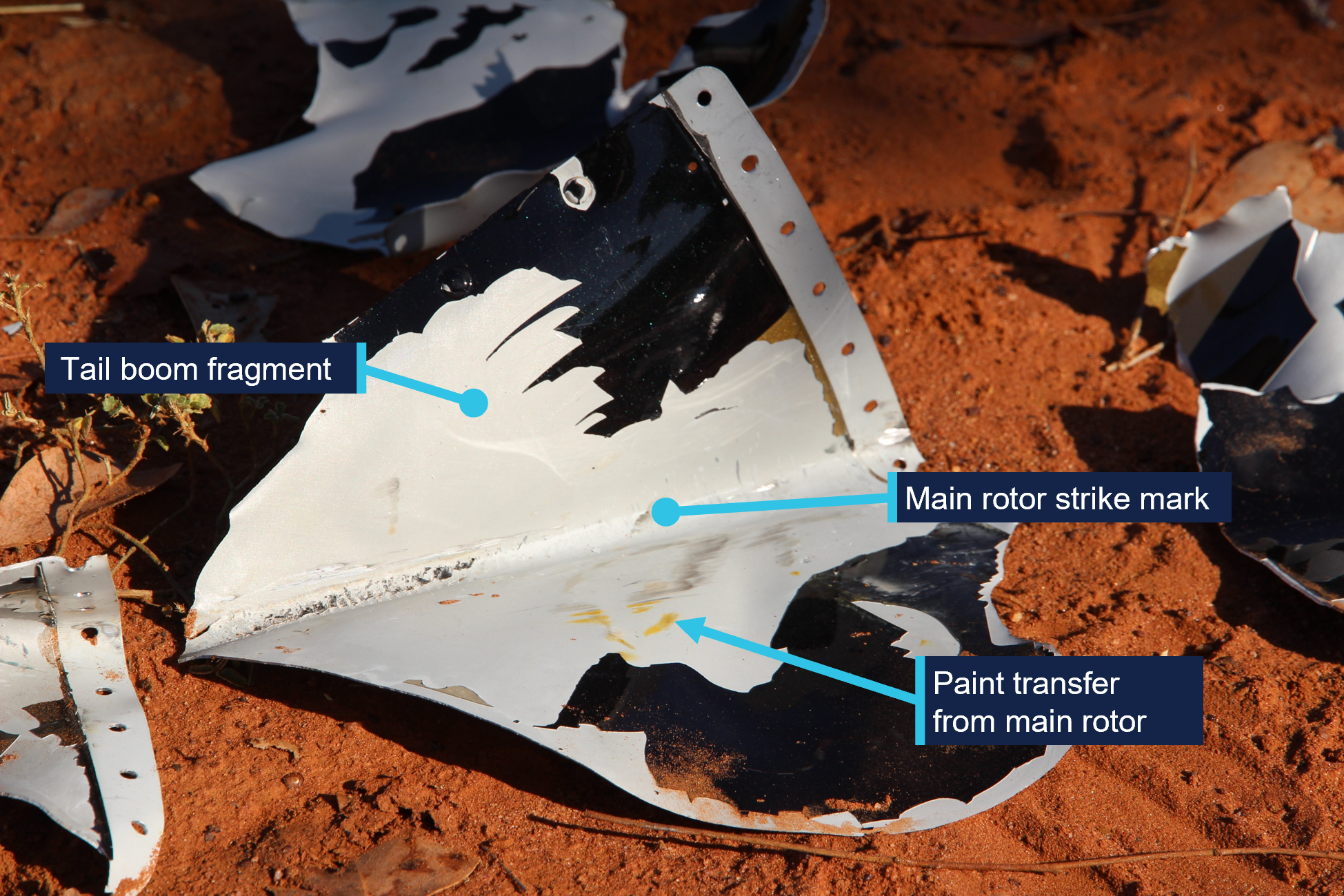 Figure 3 showing a fragment of the tail boom, paint transfer from the main rotor and a strike mark from the main rotor.