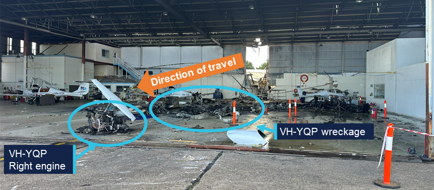 Photograph of the wreckage of the aircraft within the hangar.