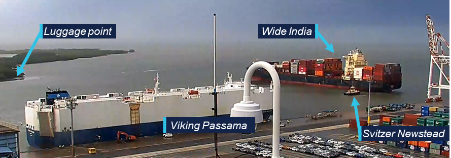 Still from CCTV camera showing Viking Passama alongside at the vehicle berth, Wide India is turning in the channel to the right with tug Svitzer Newstead in attendance.