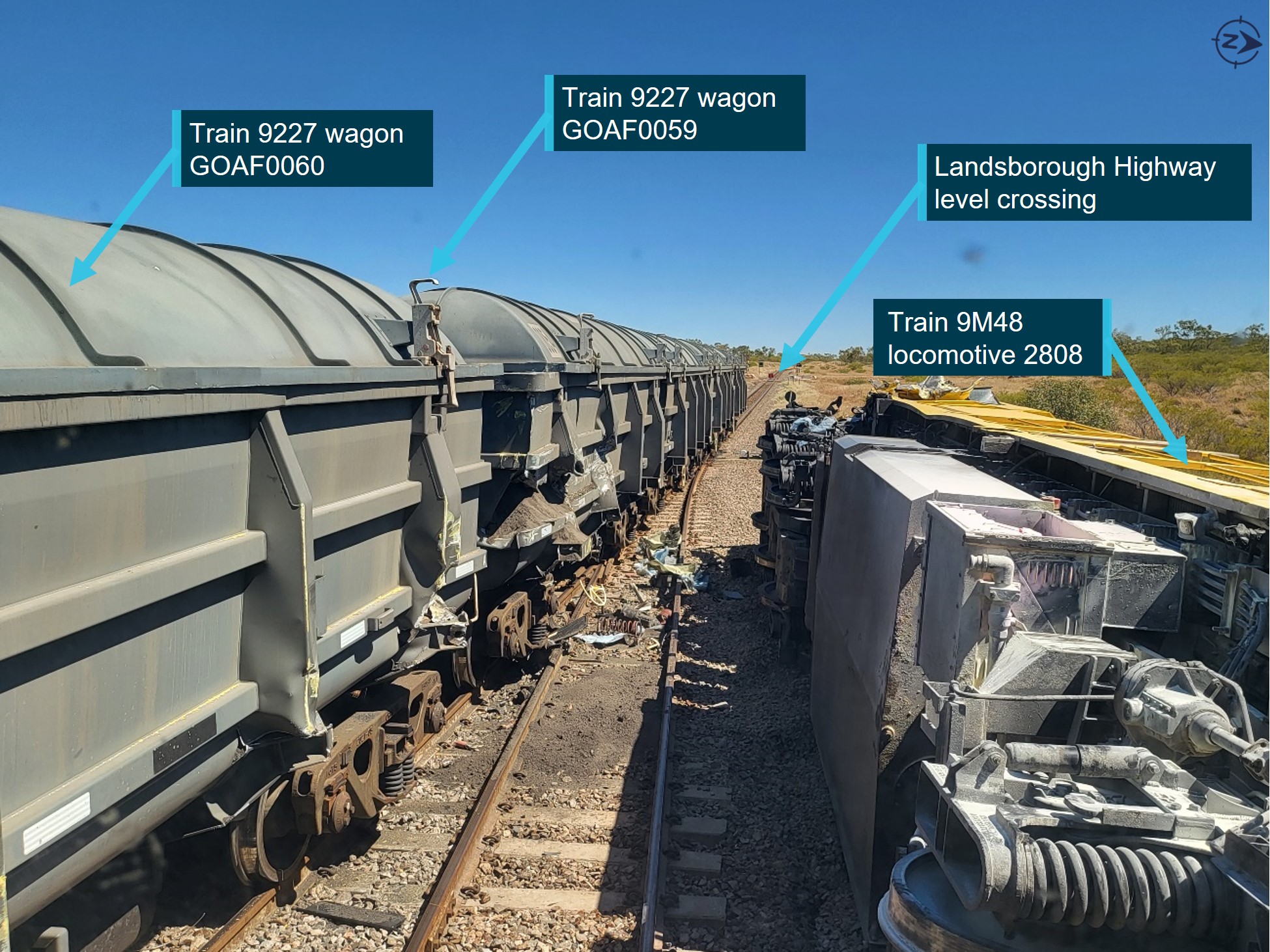 Photograph showing damage to wagons of train 9227 on left track and overturned locomotive 2808 on the right track.