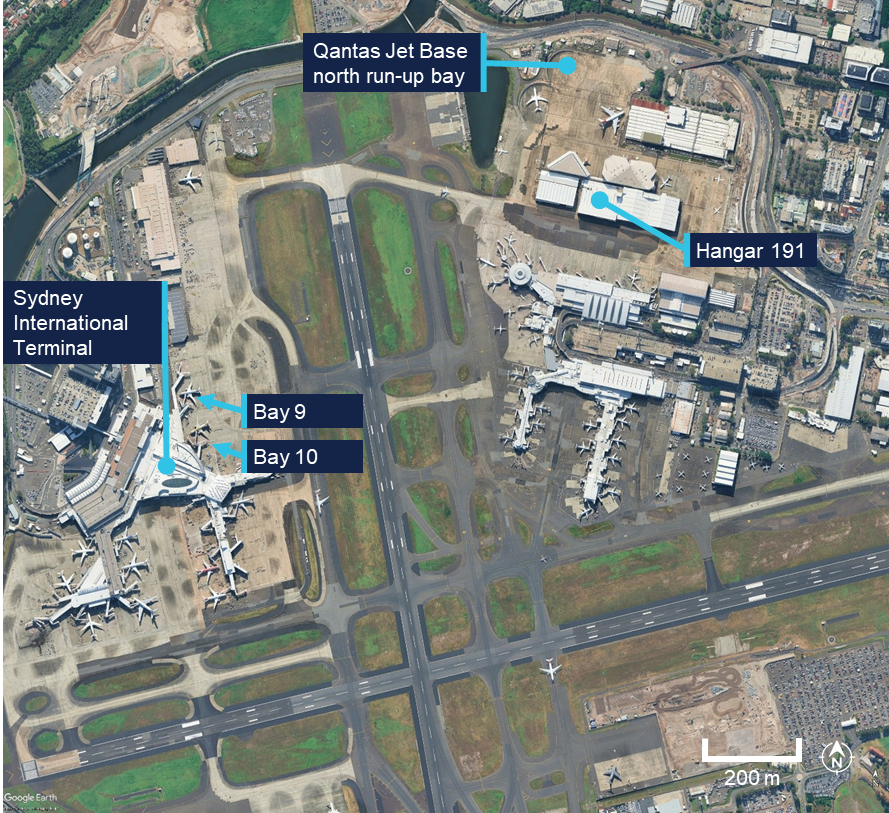 Aerial photograph of Sydney Airport showing key locations including Sydney International Terminal, Bay 9, Bay 10, Qantas Jet Base north run-up bay, and Hangar 191, each labelled with blue markers. The layout highlights runways, taxiways, aircraft parking areas, and surrounding infrastructure, with a scale bar indicating 200 metres for reference.