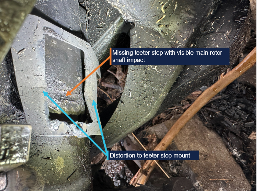 Photograph showing close-up example of damage to teeter stop and main rotor shaft on one side.