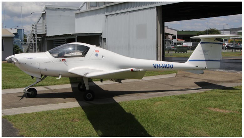 Aircraft VH-HUU in front of a hanger