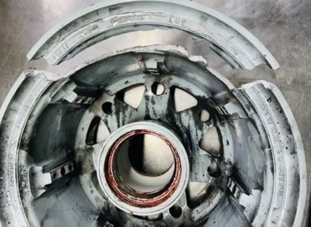 Fractured inner rim section of main landing gear wheel.
