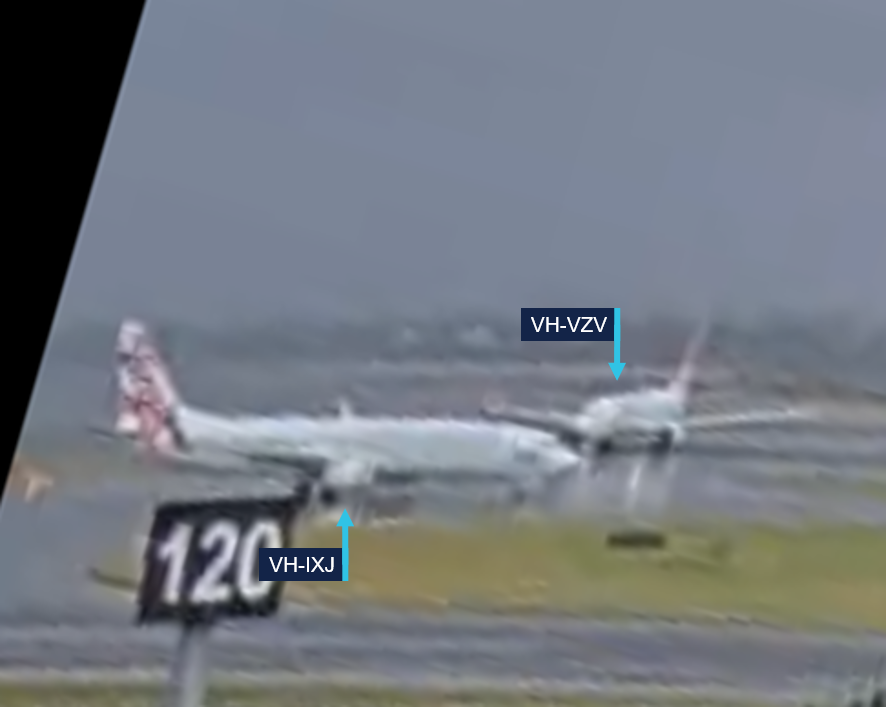A still image from Sydney Airport CCTV showing VH-IXJ passing in front of VH-VZV