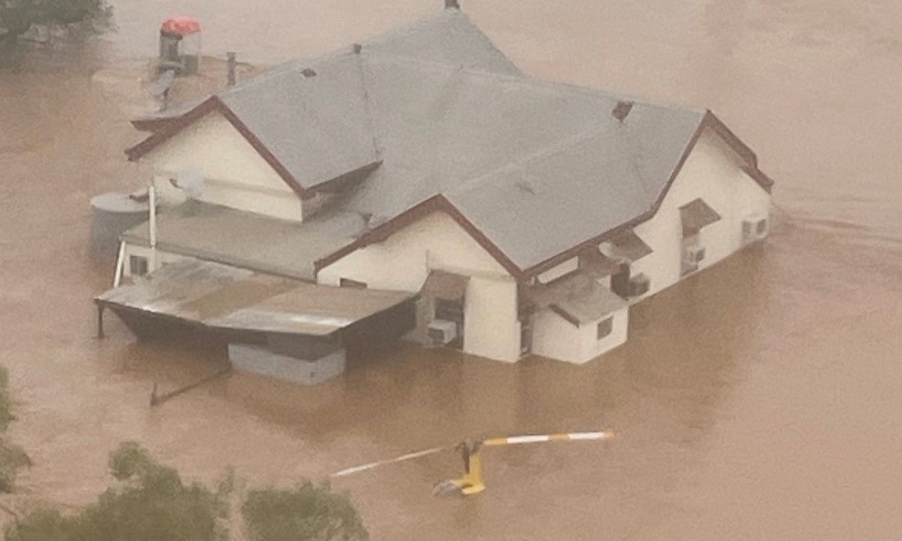 Report front cover image of the helicopter in floodwaters.