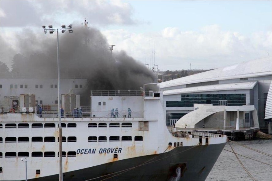 Figure 9: Ship's crewmembers fighting the fire with water hoses
