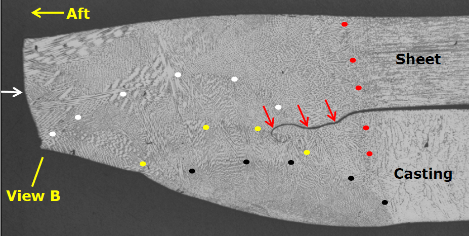 Metallographic image of a cross section of the fractured welded boss. The red dots likely indicate the original weld.