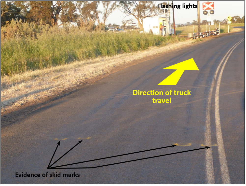 Figure 7:	View approaching railway crossing at 84 m, evidence of skid marks from road-train truck