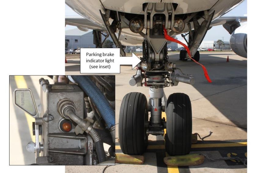 Figure 1: Nose landing gear showing the aircraft’s park brake indicator light (note the wheel chocks in place)