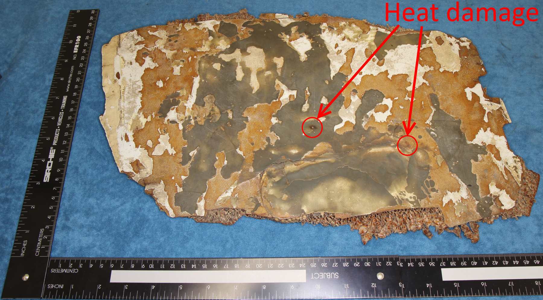 Reverse side of larger composite panel showing discrete areas of heat damage