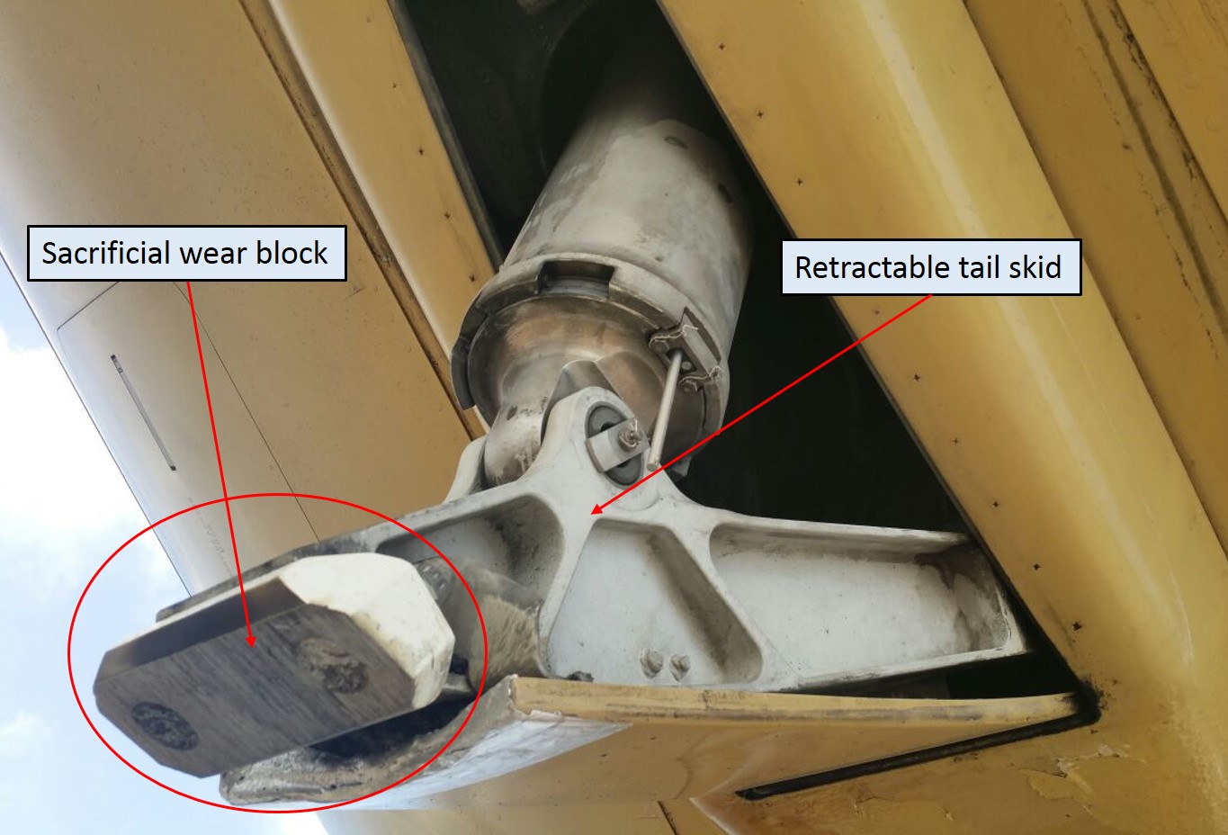Tail skid displaying erosion to the sacrificial wear block
