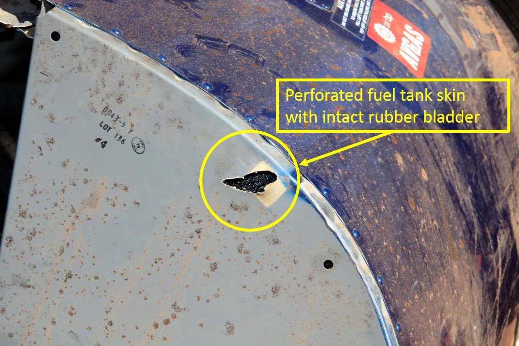 Figure 4: Perforated auxiliary fuel tank outer aluminium skin. Note the intact rubber bladder tank (circled in yellow)