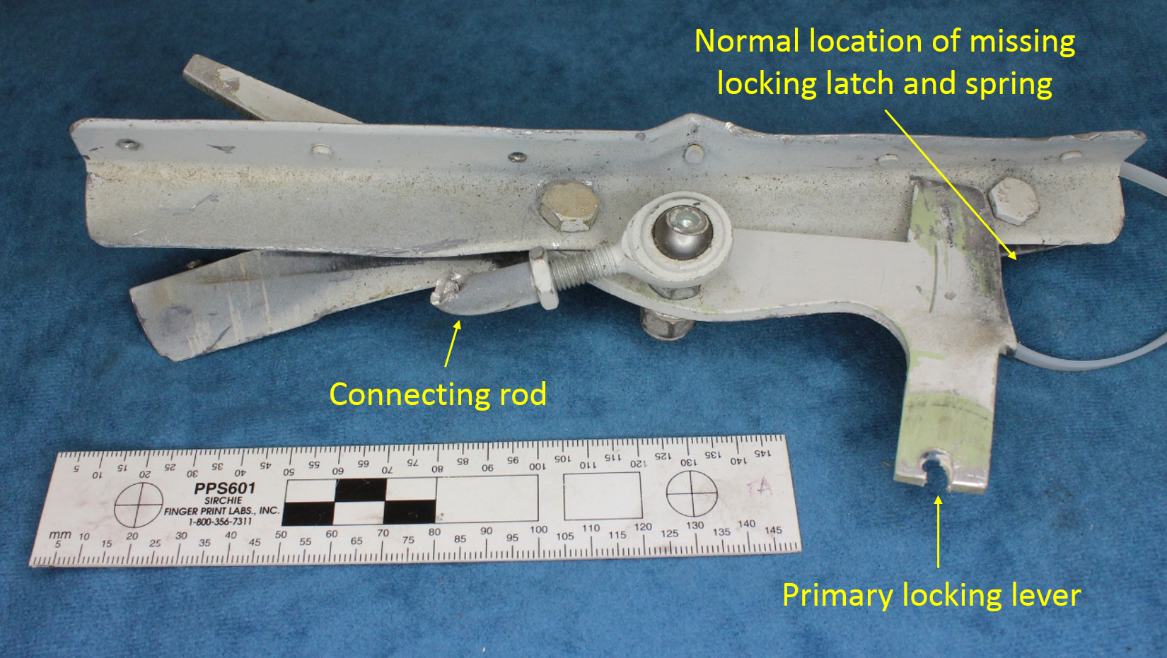 Figure 8: Primary locking lever, normal location of the missing locking catch and spring, and the fractured connecting rod