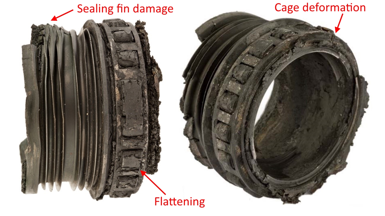 Figure 7: The seized front bearing and labyrinth seal, showing blackening from severe heat distress, flattening of the rollers, deformation of the cage and sealing fins