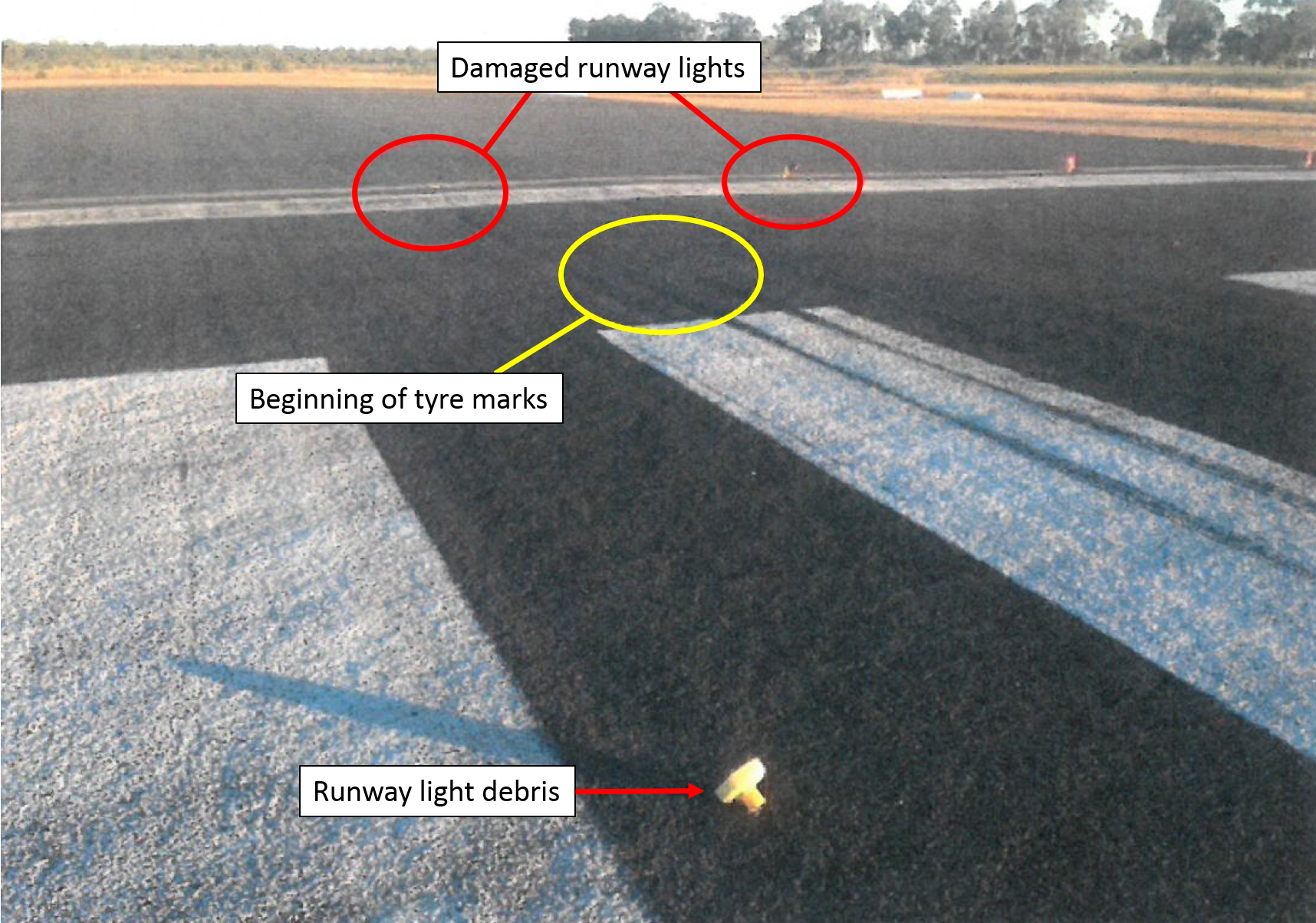 Figure 3: Runway 11 threshold. Image shows the damaged runway lights, touchdown tyre marks and runway light debris. Source: Airport operator, annotated by ATSB