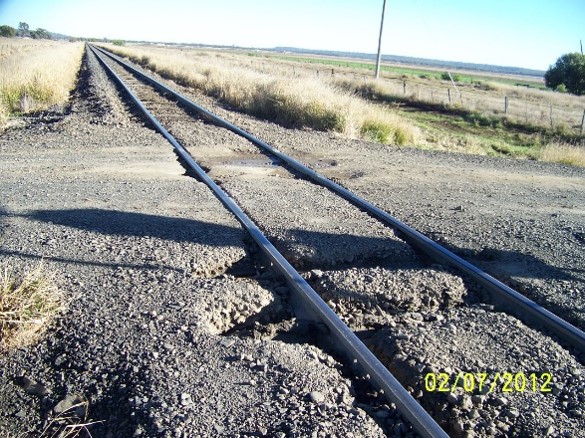 Figure 5: An image taken by the assessor during the July 2012 assessment of level crossing ID 2309. The assessors report recorded that the crossing gravel surface is breaking up and the track is ‘pumping’ and contributing to surface deterioration.<br />
Source: QR
