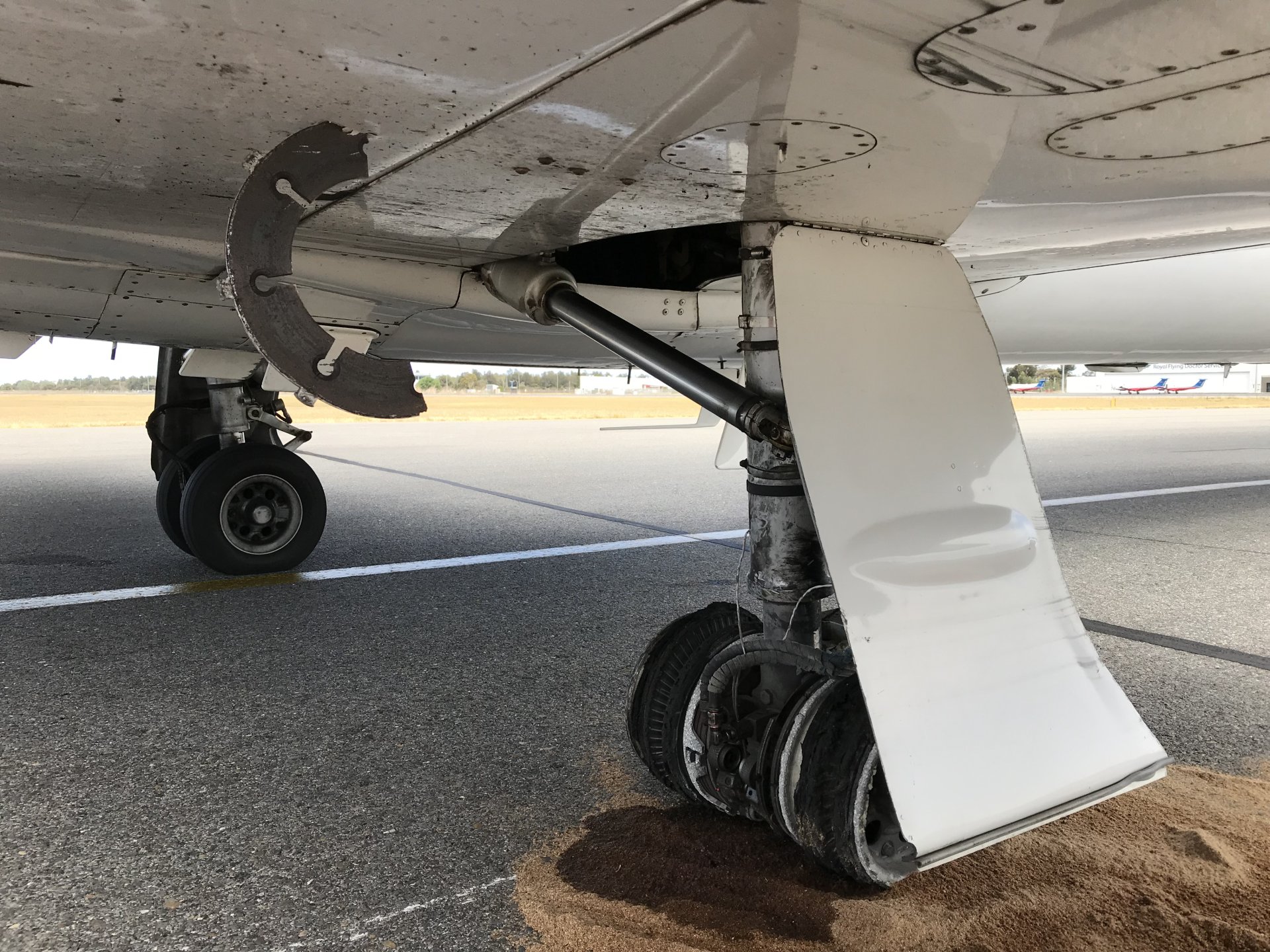 Figure 1: Damage to the right main landing gear and fuselage. Source: Adelaide Airport