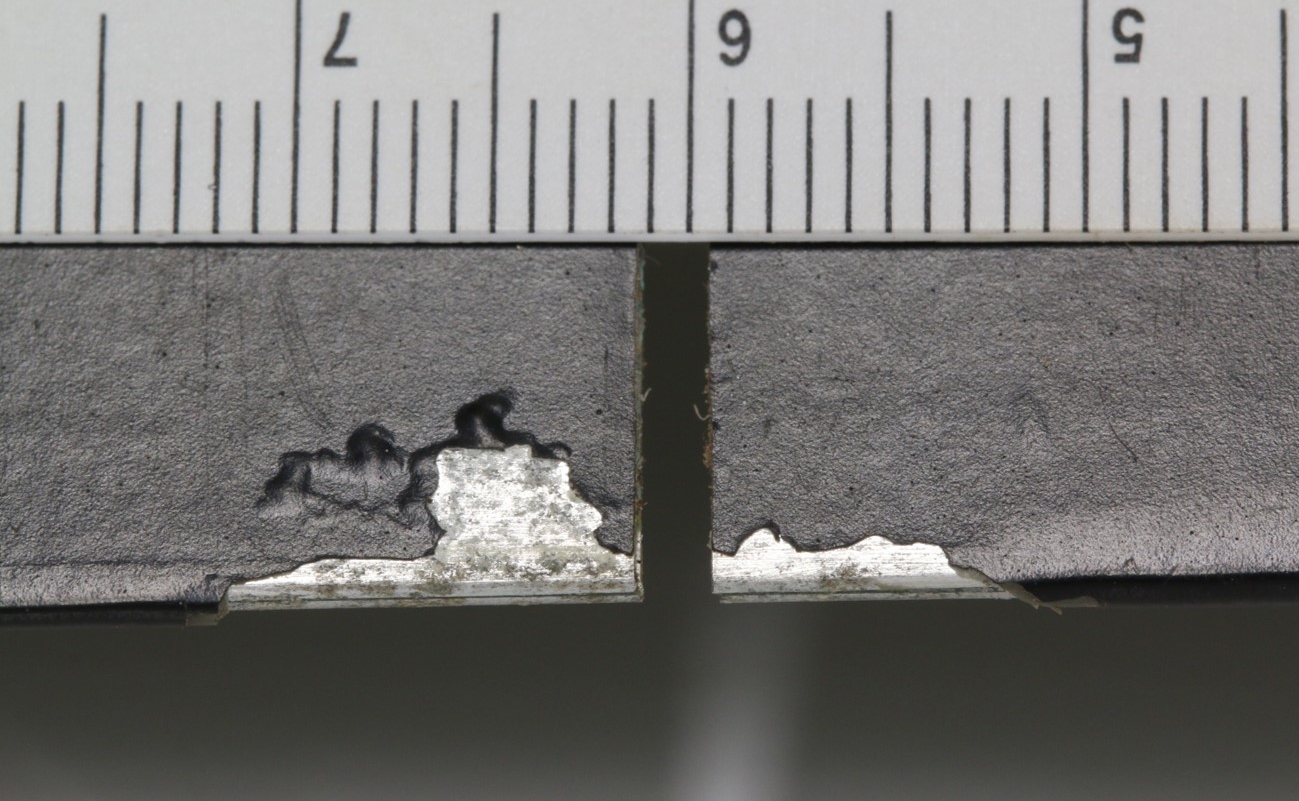 Figure 7: Trailing edge corrosion damage and paint loss to the lower surface of blade SN 0133 at rotor station 61.3.<br />
Minor surface corrosion, paint loss and bead sealant damage was identified near the crack origin on both the upper and lower surfaces.<br />
Source: ATSB