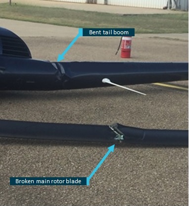 Figure 2: Helicopter’s bent tail boom and broken main rotor blade.<br />
Source: Townsville Airport