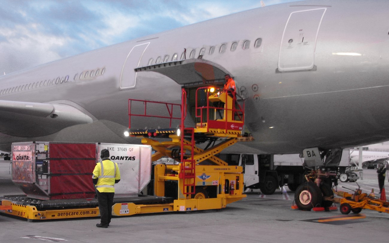 Figure 4: Sample unit load devices being loaded into an A330 forward hold.Image source: Source ATSB, image digitally altered to remove aircraft operator logos